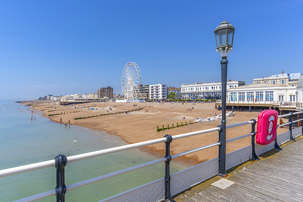 View of beach front houses and ferris wheel from the pier, Worthing, West Sussex, England, United Kingdom, Europe