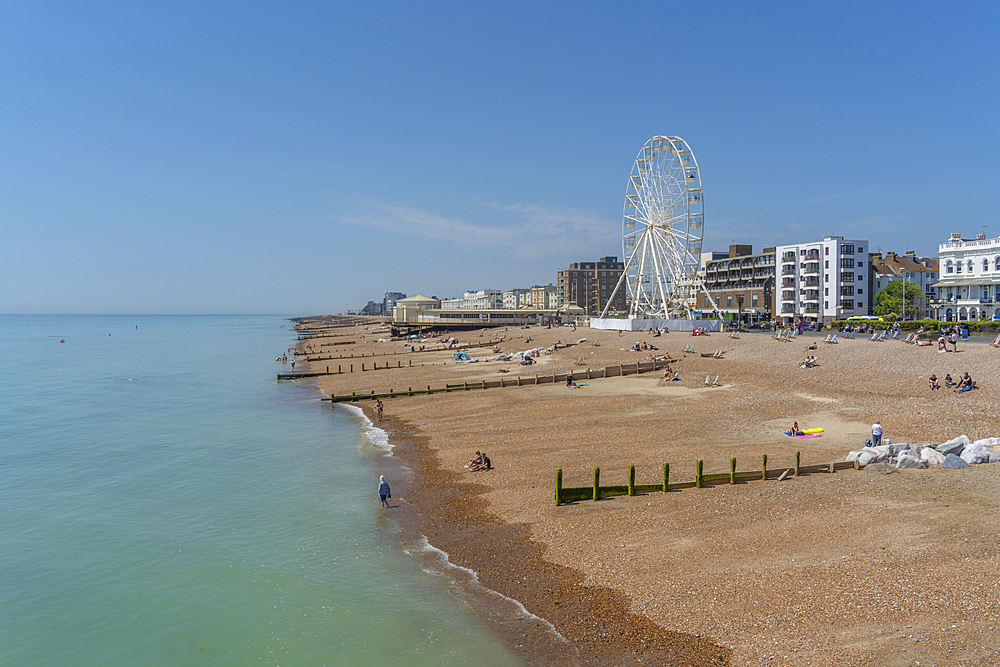 View of beach front houses and ferris wheel from the pier, Worthing, West Sussex, England, United Kingdom, Europe