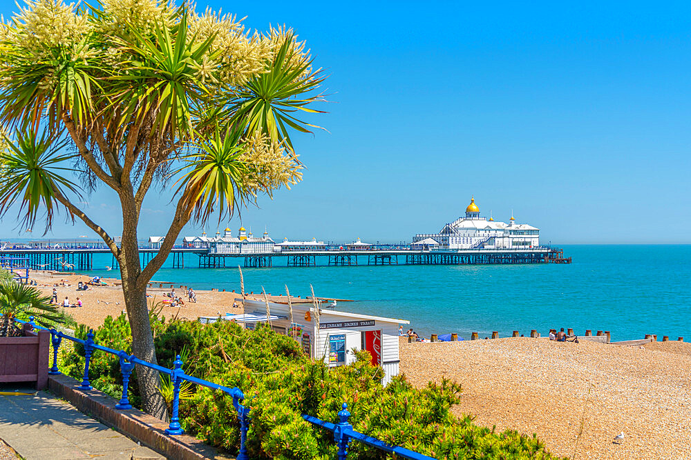 View of sea front promenade, pier and beach in summer time, Eastbourne, East Sussex, England, United Kingdom, Europe