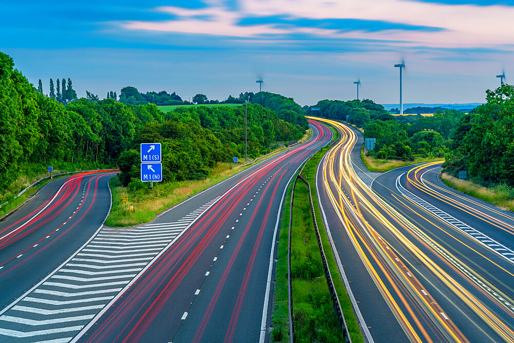 View of trail lights on the intersection of M1 and M18 Motorways at dusk in South Yorkshire, Sheffield, England, United Kingdom, Europe