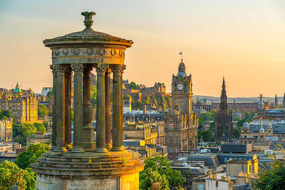 View of Edinburgh Castle, Balmoral Hotel and Dugald Stewart monument from Calton Hill at golden hour, UNESCO World Heritage Site, Edinburgh, Lothian, Scotland, United Kingdom, Europe