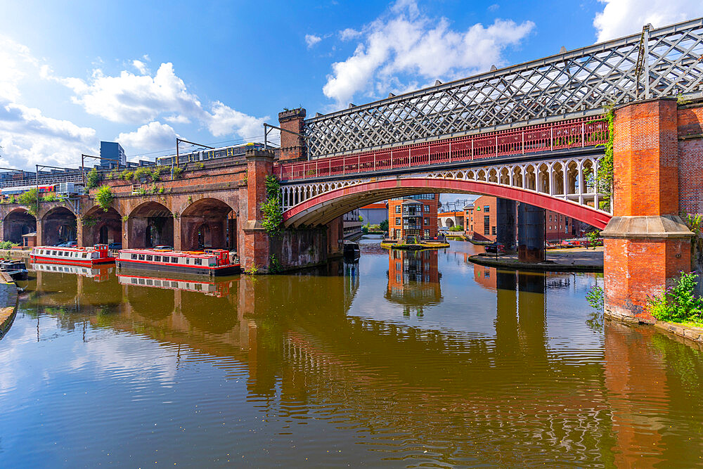 View of tram and train bridges reflecting in Castlefield Canal, Castlefield, Manchester, England, United Kingdom, Europe