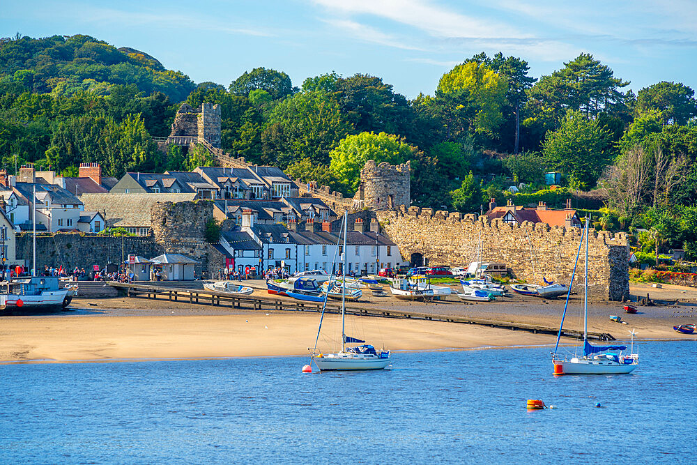 View of boats of the Conwy River and town wall, Conwy, Gwynedd, North Wales, United Kingdom, Europe