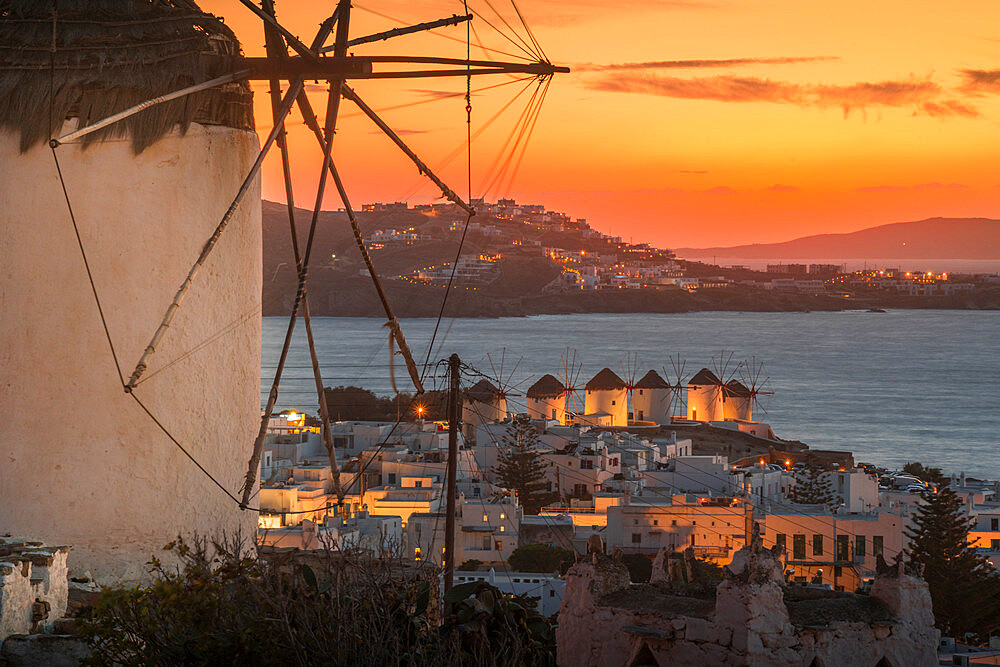 View of the windmills and town from elevated position at dusk, Mykonos Town, Mykonos, Cyclades Islands, Greek Islands, Aegean Sea, Greece, Europe