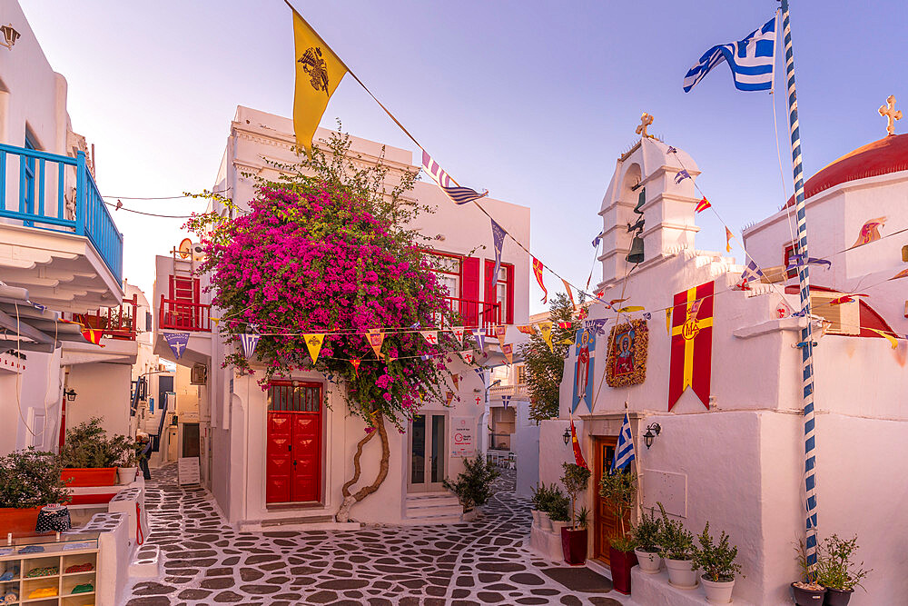 View of whitewashed chapel in narrow street at golden hour, Mykonos Town, Mykonos, Cyclades Islands, Greek Islands, Aegean Sea, Greece, Europe