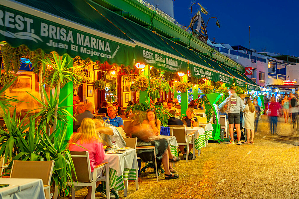 View of restaurants and shops overlooking Playa Blanca Beach at dusk, Playa Blanca, Lanzarote, Canary Islands, Spain, Atlantic, Europe