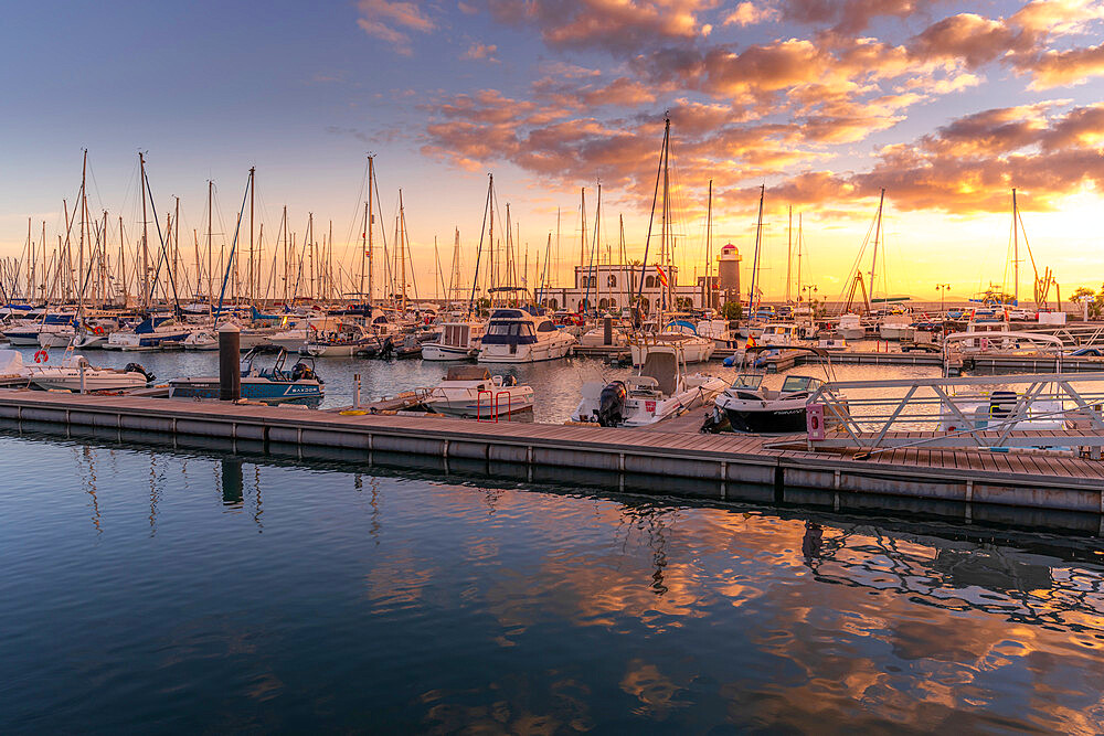 View of boats and lighthouse in Marina Rubicon at sunset, Playa Blanca, Lanzarote, Canary Islands, Spain, Atlantic, Europe