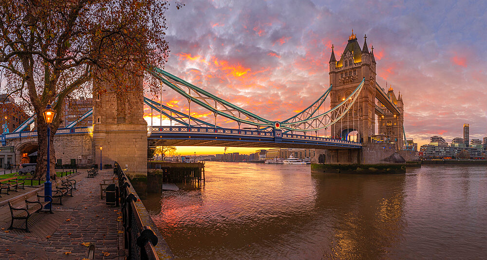 Panoramic view of Tower Bridge and River Thames with dramatic sky at sunrise, London, England, United Kingdom, Europe