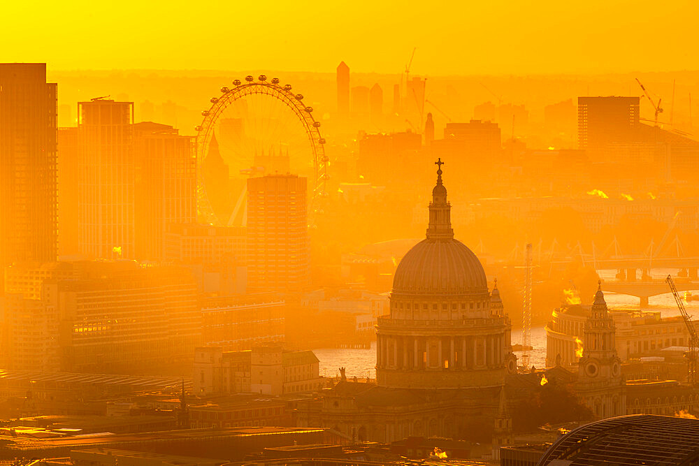 View of London Eye and St. Paul's Cathedral at golden hour from the Principal Tower, London, England, United Kingdom, Europe