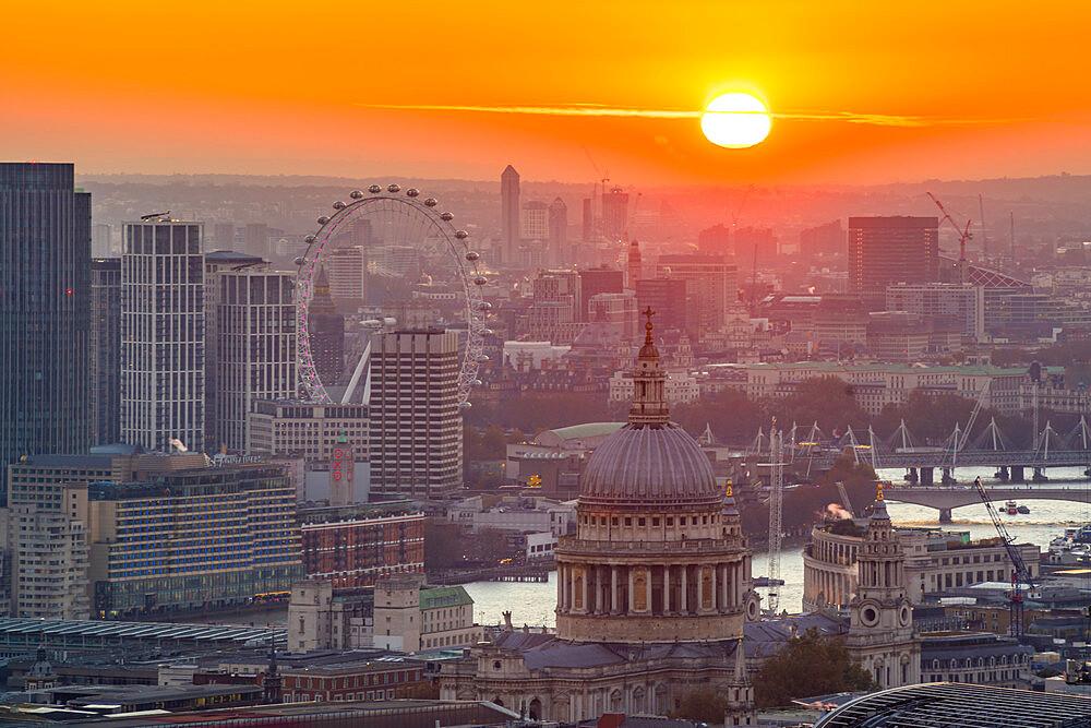 View of sun setting over London Eye and St. Paul's Cathedral from the Principal Tower, London, England, United Kingdom, Europe