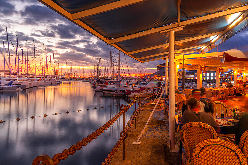 View of boats and Marina Rubicon Shopping Center from restaurant at sunset, Playa Blanca, Lanzarote, Canary Islands, Spain, Atlantic, Europe