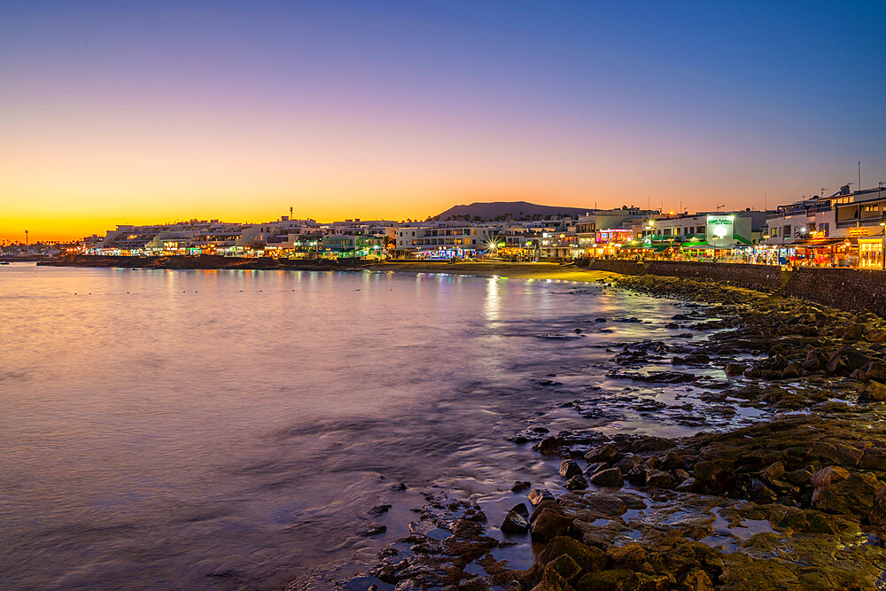 View of beach and cafes and bars at dusk, Playa Blanca, Lanzarote, Canary Islands, Spain, Atlantic, Europe