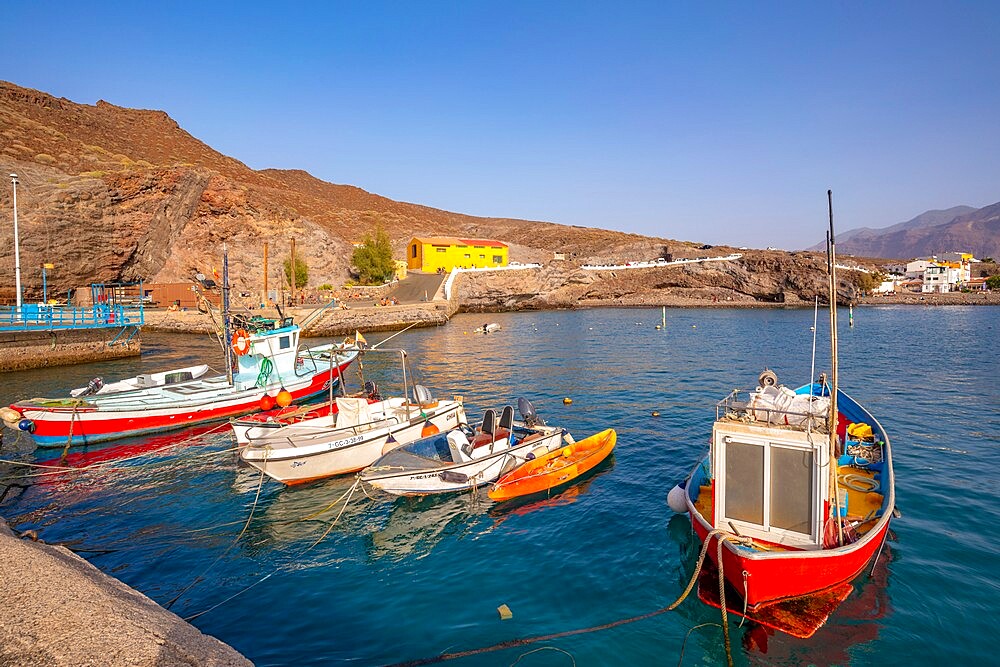 View of colourful boats in harbour and mountains in background, Puerto de La Aldea, Gran Canaria, Canary Islands, Spain, Atlantic, Europe