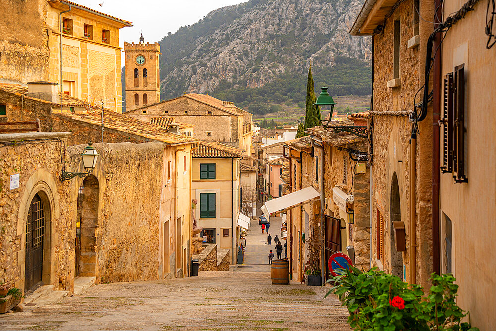 View of church clock tower and street in the old town of Pollenca, Pollenca, Majorca, Balearic Islands, Spain, Mediterranean, Europe