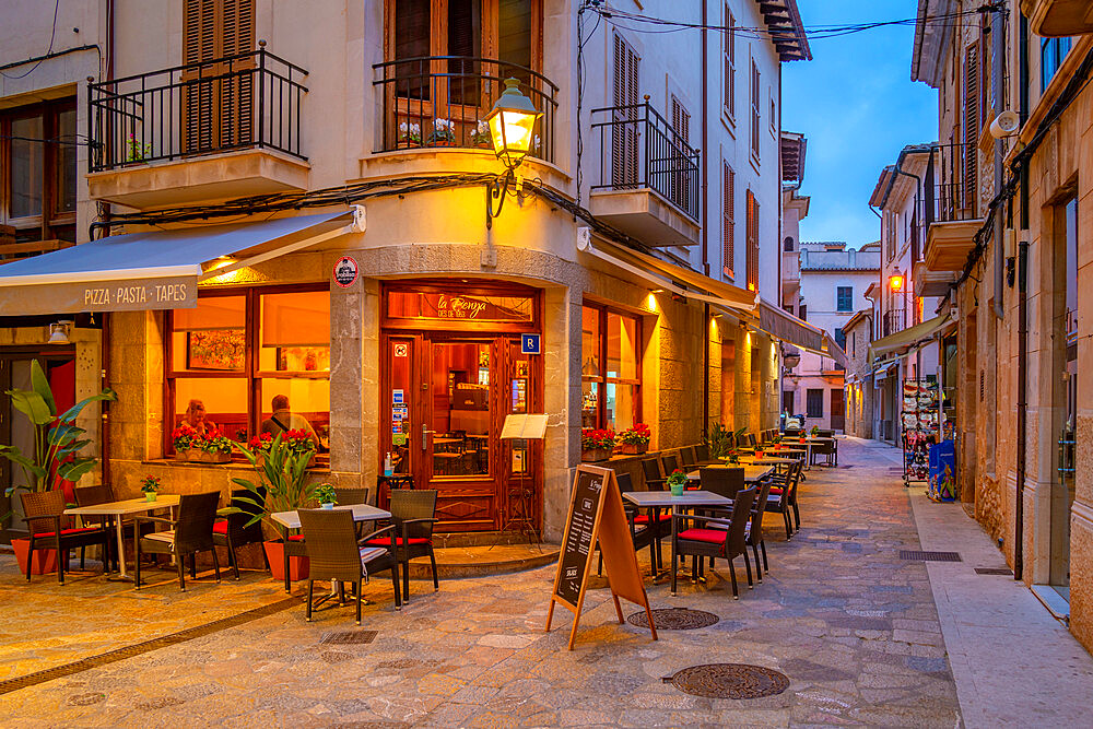 View of bar in narrow street in the old town of Pollenca at dusk, Pollenca, Majorca, Balearic Islands, Spain, Mediterranean, Europe