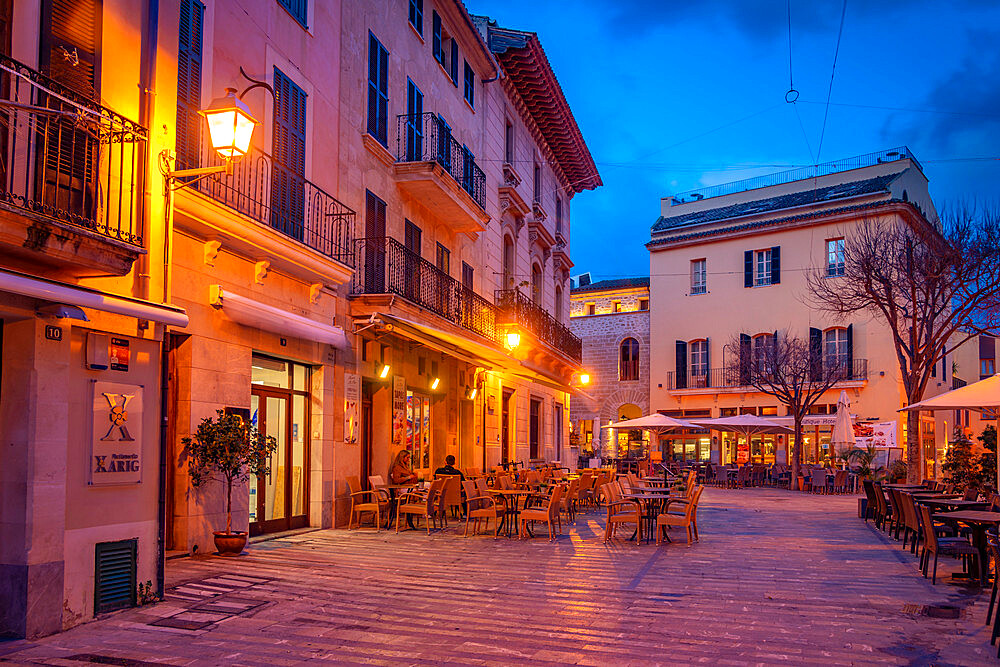 Al fresco eating in local square in the old town of Alcudia at dusk, Alcudia, Majorca, Balearic Islands, Spain, Mediterranean, Europe