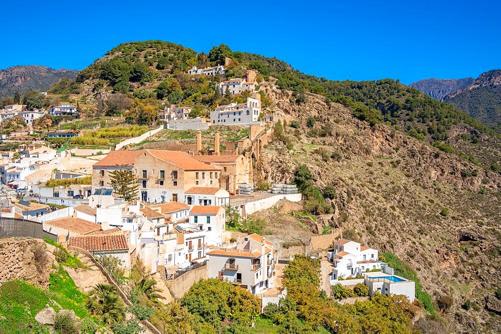 View of white washed houses and mountains in background, Frigiliana, Malaga Province, Andalucia, Spain, Europe