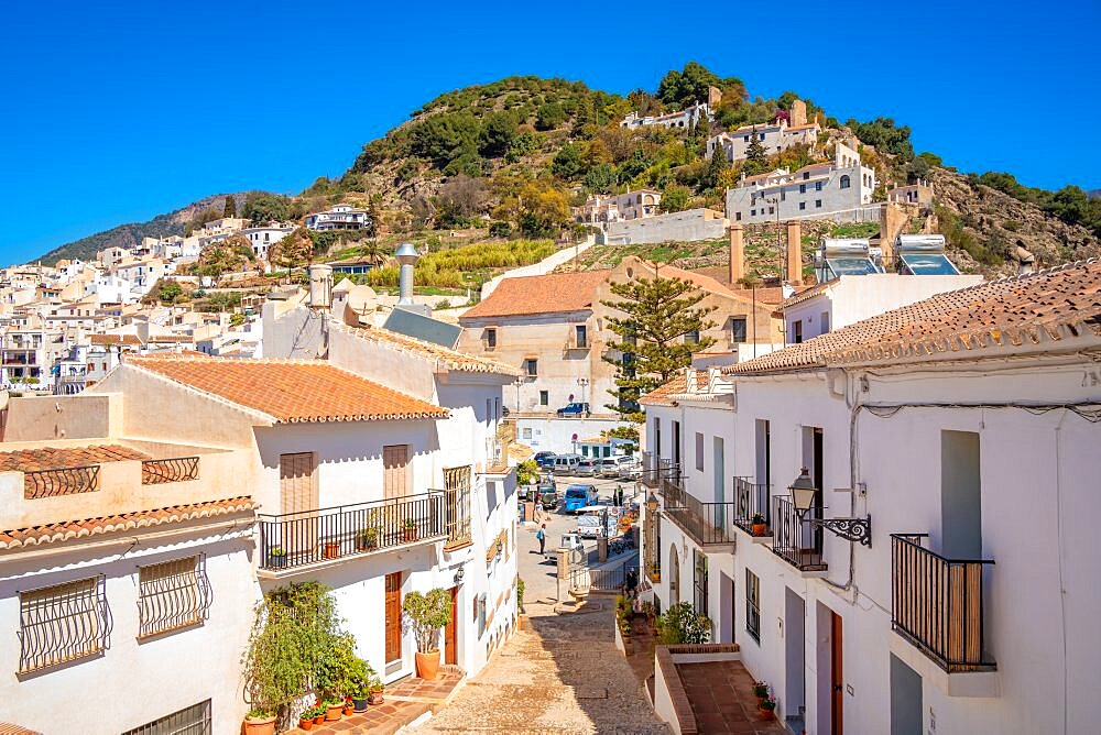 View of white washed houses and mountains in background, Frigiliana, Malaga Province, Andalucia, Spain, Europe