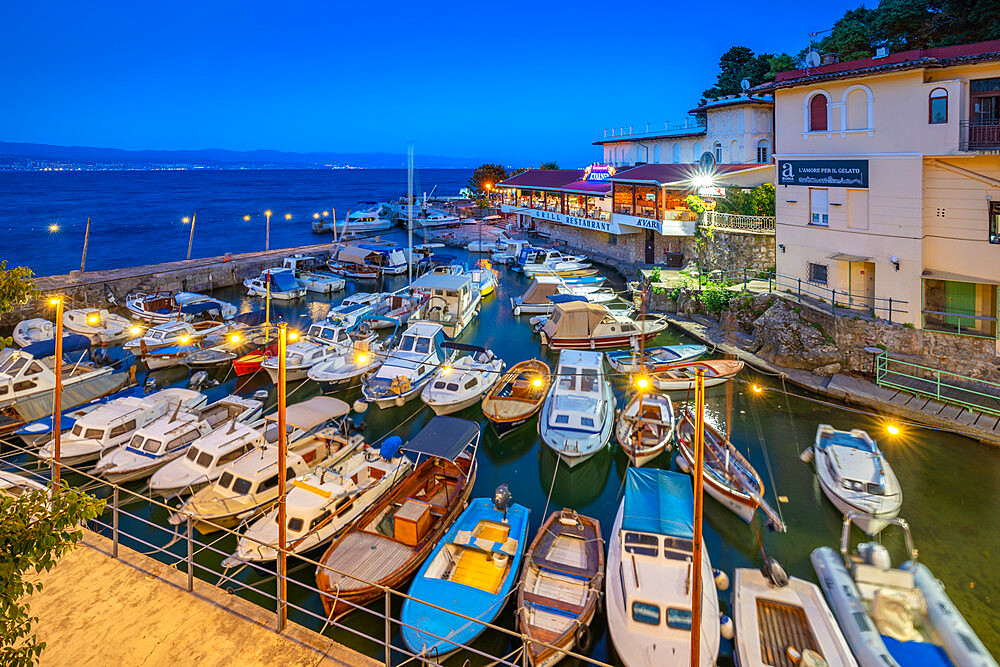 View of cafe and restaurant overlooking harbour at dusk, Lovran village, Lovran, Kvarner Bay, Eastern Istria, Croatia, Europe