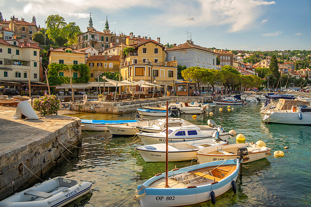 View of boats in the marina and harbourside restaurants during golden hour in Volosko, Opatija, Kvarner Bay, Croatia, Europe