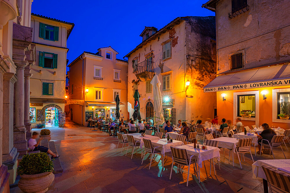 View of restaurants at dusk, Lovran, Kvarner Bay, Eastern Istria, Croatia, Europe