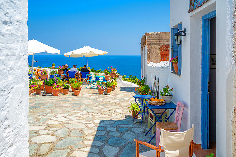 View of whitewashed cafe overlooking sea, Skopelos Town, Skopelos Island, Sporades Islands, Greek Islands, Greece, Europe