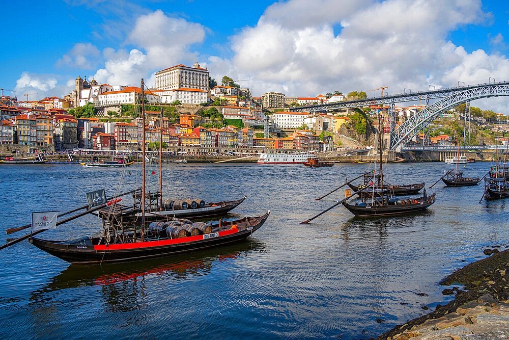 View of the Dom Luis I bridge over Douro River and Rabelo boats aligned with colourful buildings, UNESCO World Heritage Site, Porto, Norte, Portugal, Europe