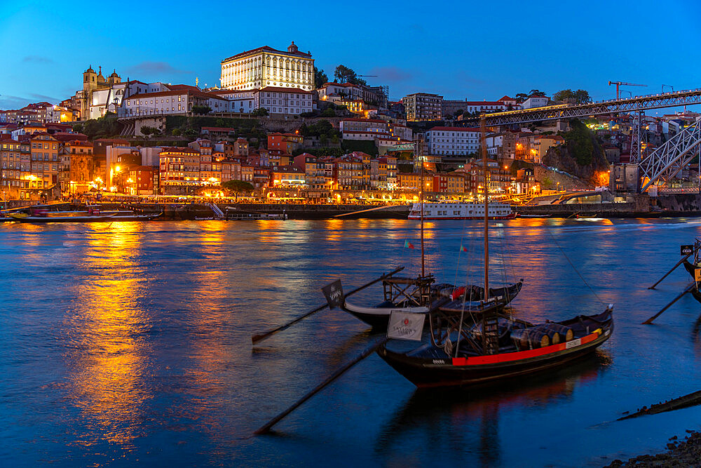 View of Douro River and Rabelo boats aligned with colourful buildings at dusk, Porto, Norte, Portugal, Europe