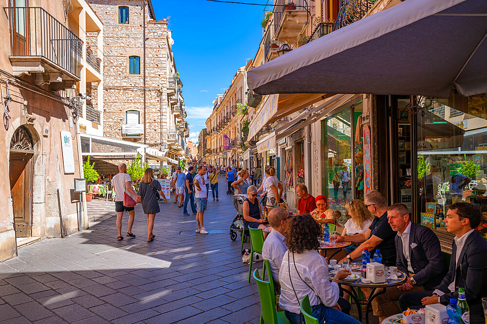 View of cafes and restaurants on busy street in Taormina, Taormina, Sicily, Italy, Mediterranean, Europe