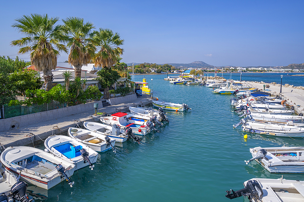 View of Faliraki Harbour and little white chapel, Faliraki, Rhodes, Dodecanese Island Group, Greek Islands, Greece, Europe