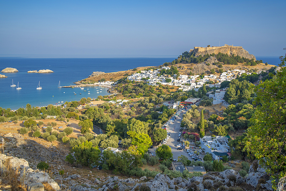 View of sailboats in the bay, Lindos and Lindos Acropolis from elevated position, Lindos, Rhodes, Dodecanese Island Group, Greek Islands, Greece, Europe