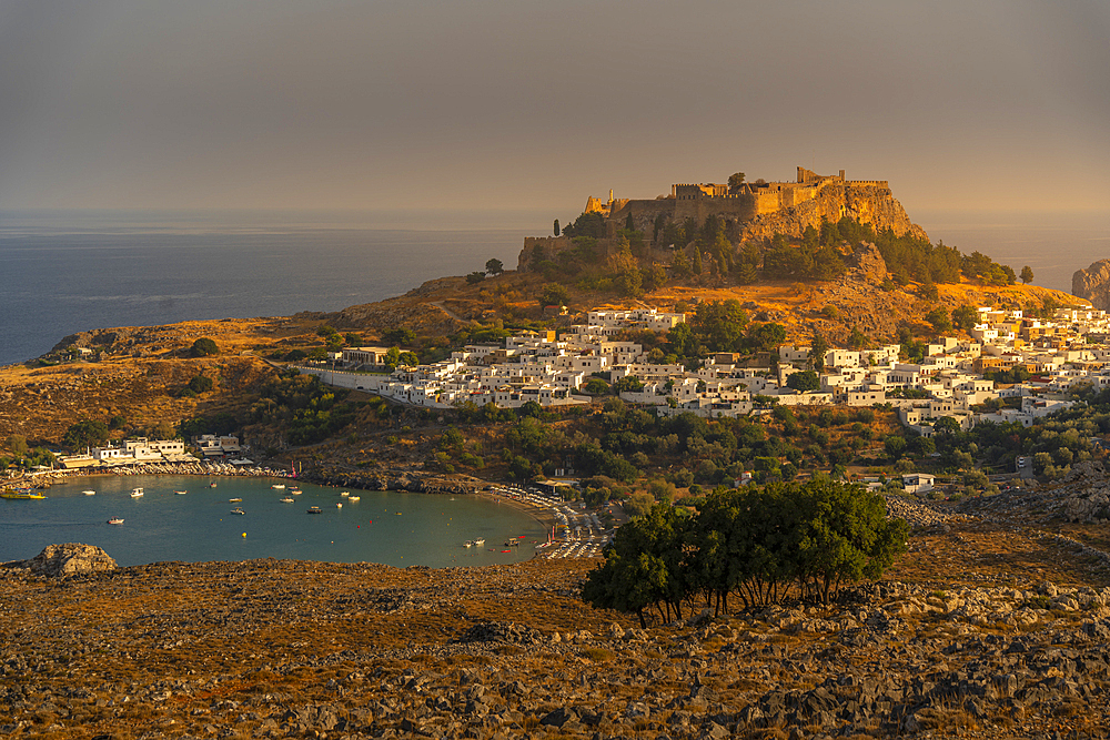 View of sailboats in the bay, Lindos and Lindos Acropolis from elevated position, Lindos, Rhodes, Dodecanese Island Group, Greek Islands, Greece, Europe