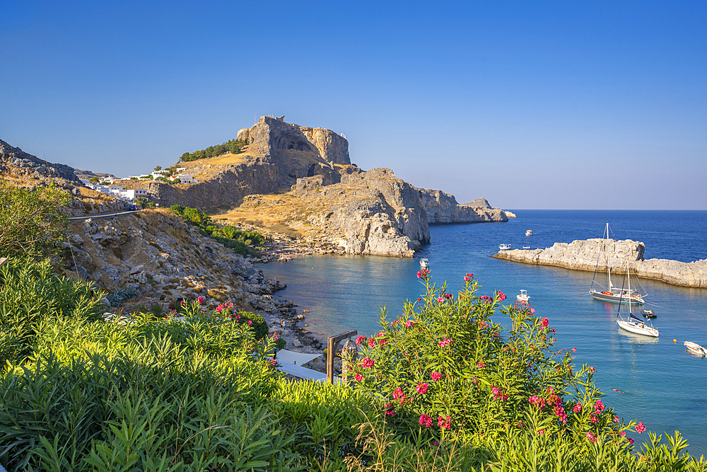 View of sailboats in the bay, Lindos and Lindos Acropolis from elevated position, Lindos, Rhodes, Dodecanese Island Group, Greek Islands, Greece, Europe