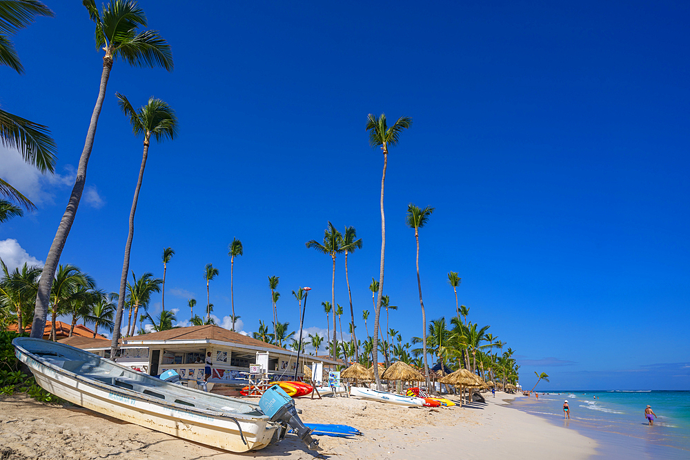 View of boat and palm trees on Bavaro Beach, Punta Cana, Dominican Republic, West Indies, Caribbean, Central America