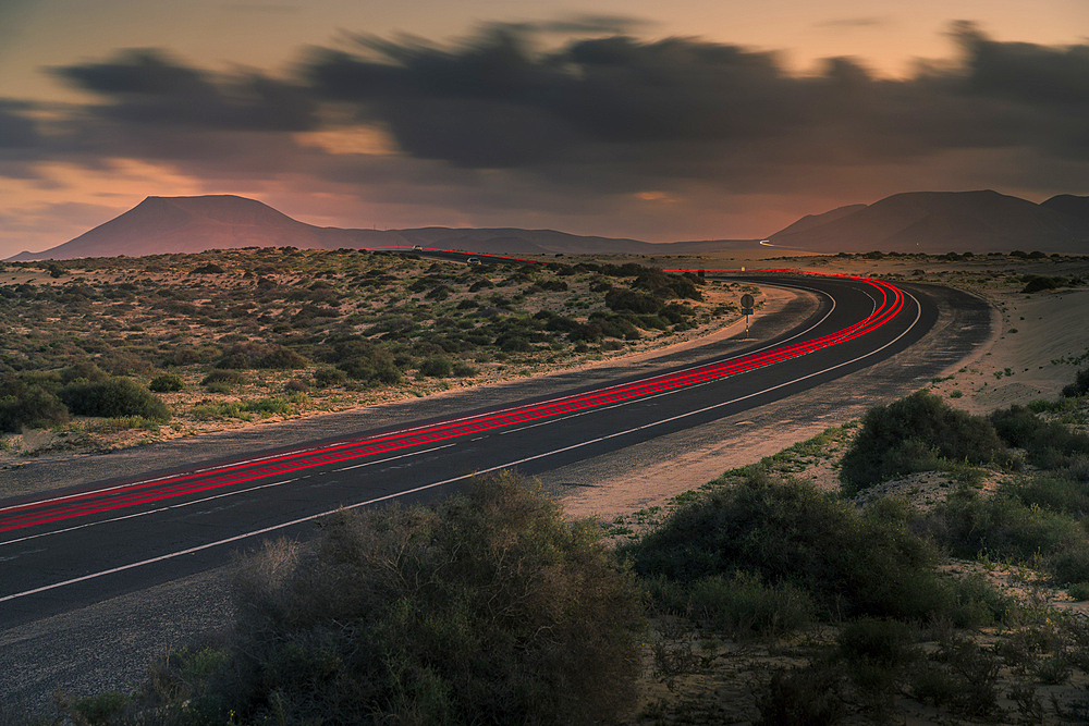 View of trail lights, sand dunes and mountains at dusk, Corralejo Natural Park, Fuerteventura, Canary Islands, Spain, Atlantic, Europe