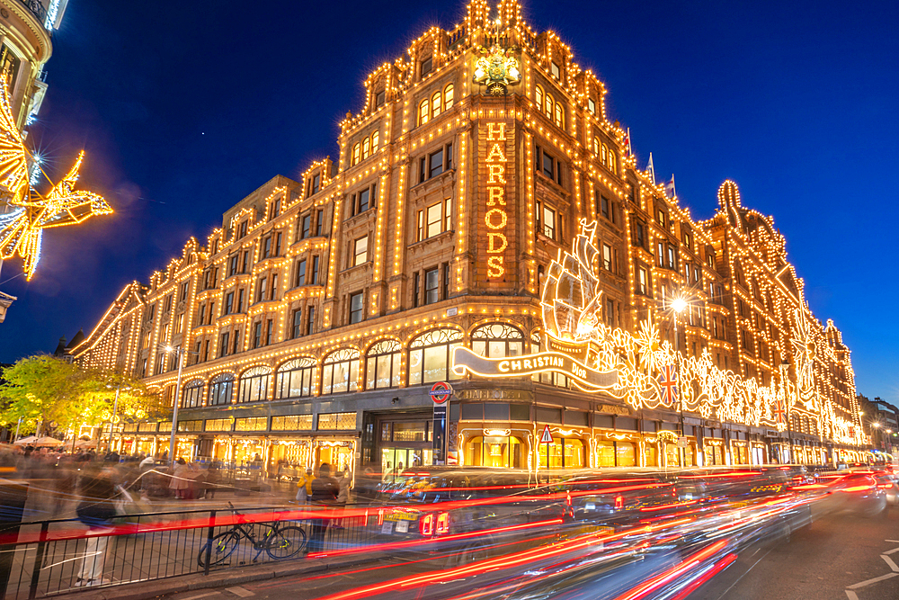 View of Harrods department store illuminated at dusk, Knightsbridge, London, England, United Kingdom, Europe