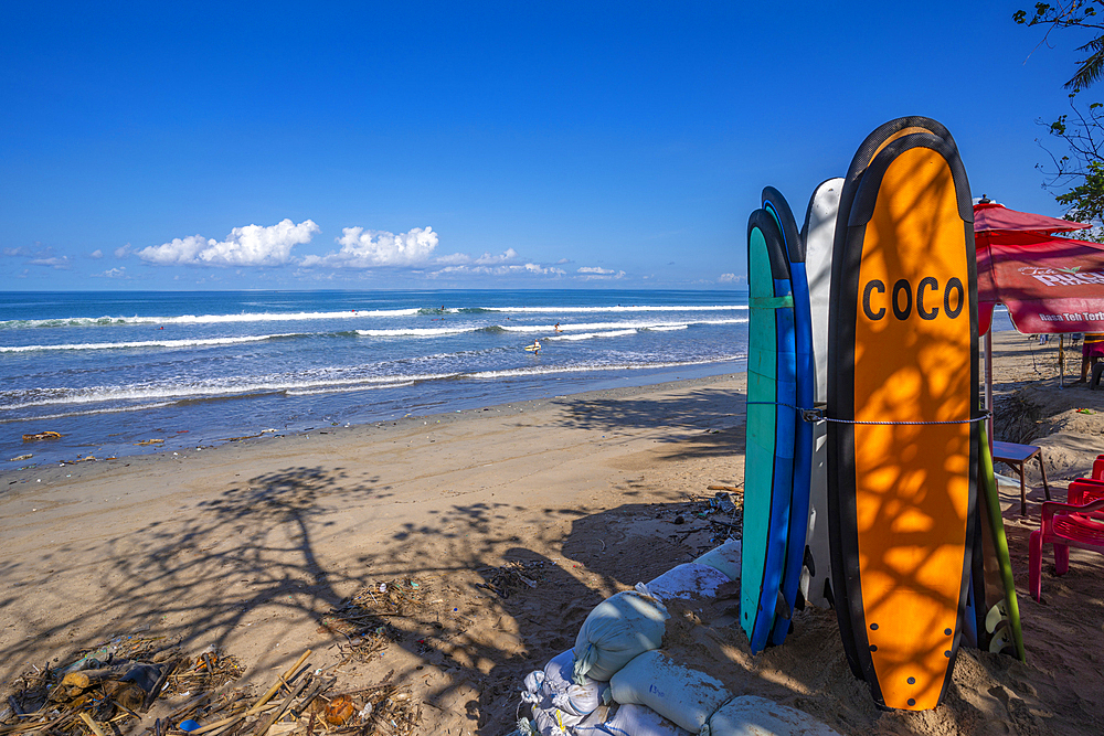 View of surf boards and vendors on sunny morning on Kuta Beach, Kuta, Bali, Indonesia, South East Asia, Asia