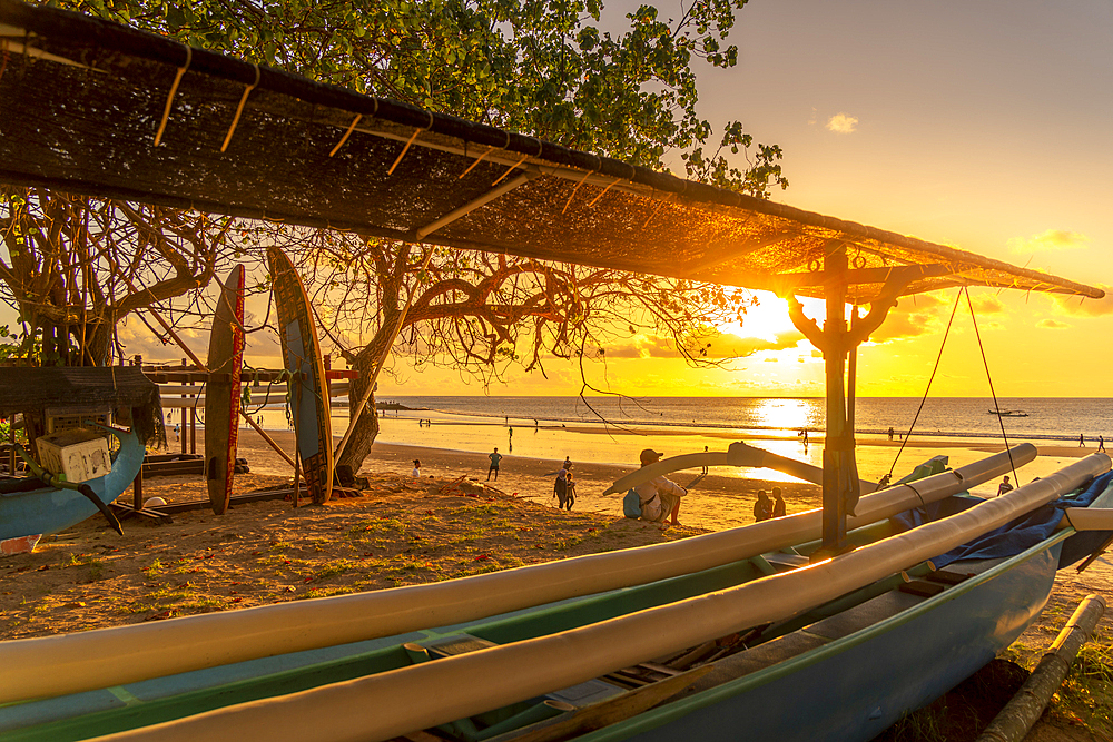 View of fishing outrigger overlooking Kuta Beach at sunset, Kuta, Bali, Indonesia, South East Asia, Asia