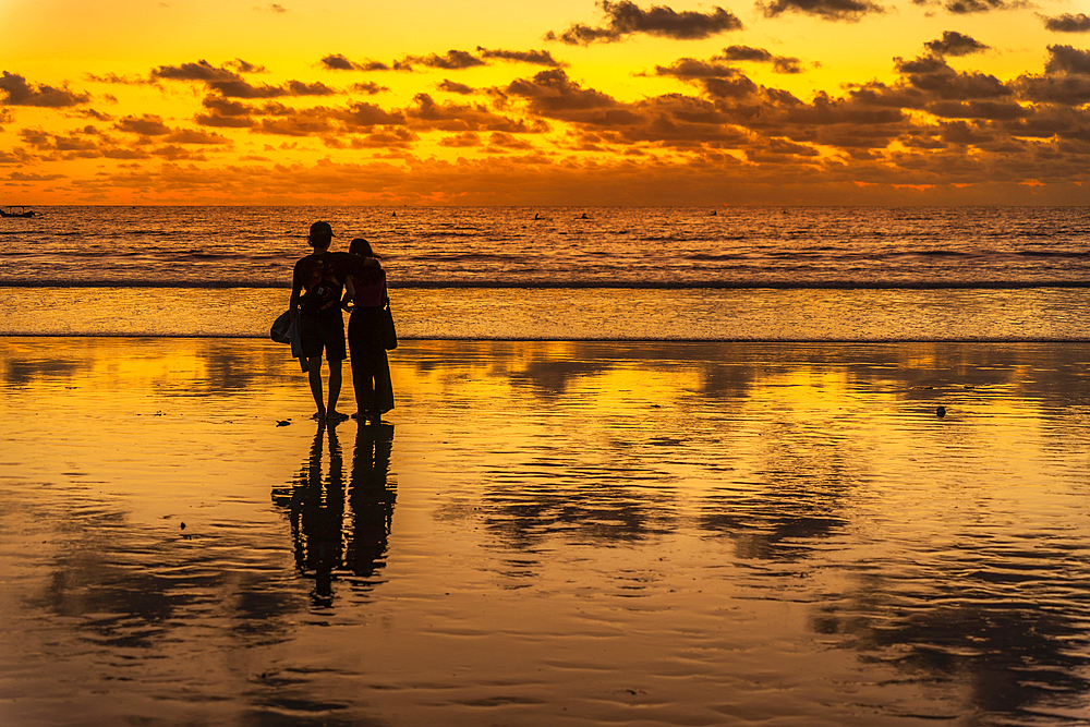 View of couple at sunset on Kuta Beach, Kuta, Bali, Indonesia, South East Asia, Asia