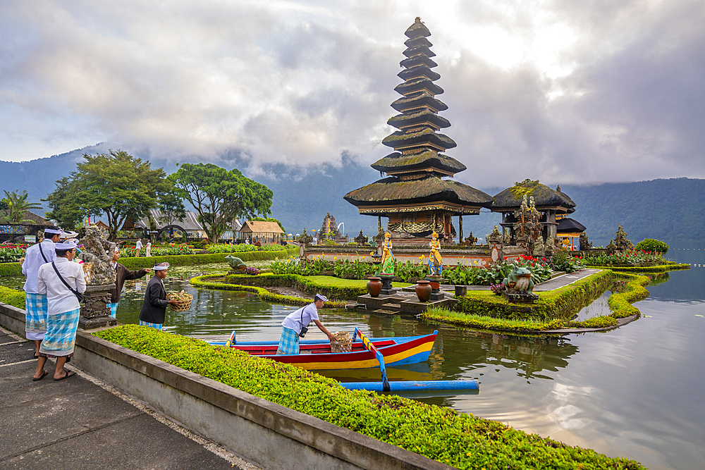 View of offerings being made at Ulun Danu Beratan temple on Lake Bratan at sunrise, Bali, Indonesia, South East Asia, Asia