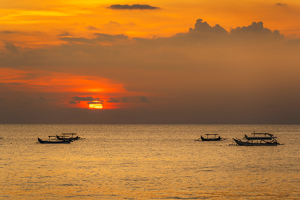 View of sunset and fishing outriggers on Indian Ocean from Kuta Beach, Kuta, Bali, Indonesia, South East Asia, Asia