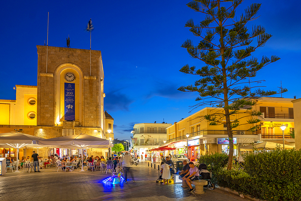 View of cafe and restaurant in Eleftherias Central Square in Kos Town at dusk, Kos, Dodecanese, Greek Islands, Greece, Europe