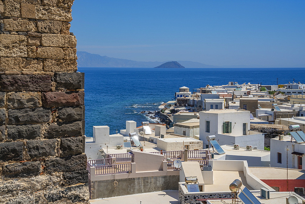 View of sea and whitewashed buildings and rooftops of Mandraki, Mandraki, Nisyros, Dodecanese, Greek Islands, Greece, Europe