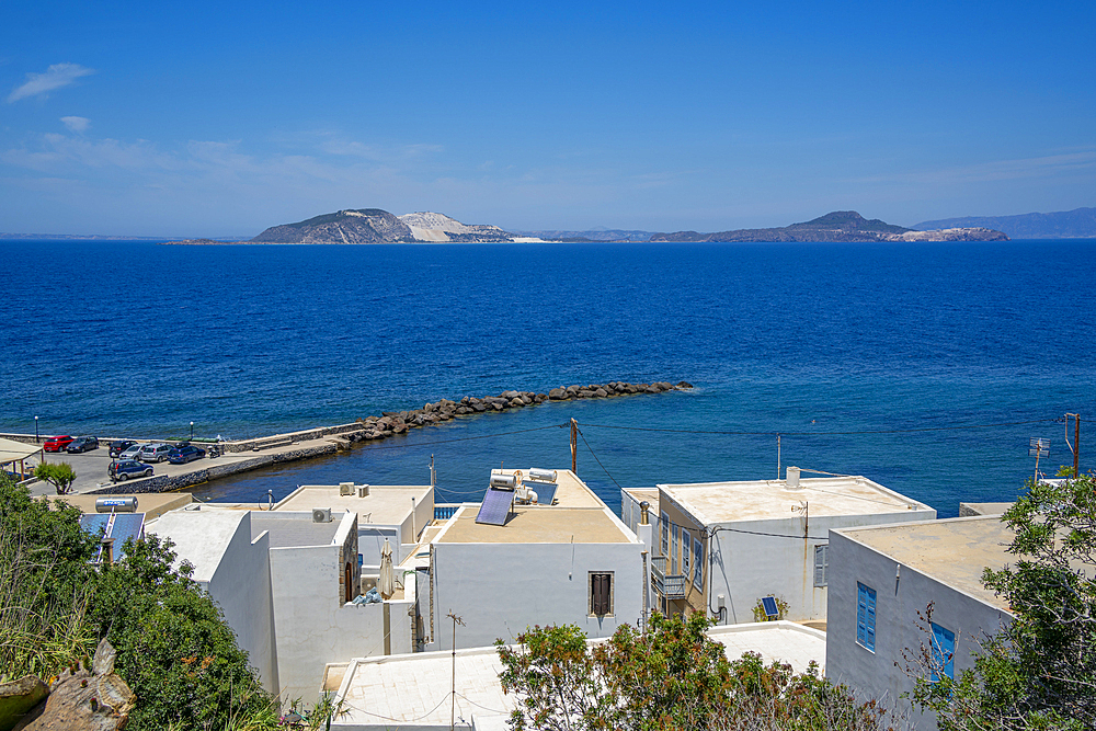 View of rooftops and the sea in the town of Mandraki, Mandraki, Nisyros, Dodecanese, Greek Islands, Greece, Europe