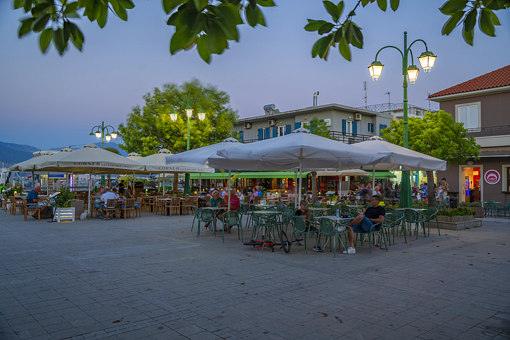 View of cafe and bar in Plateía Central Square at dusk, Lixouri, Kefalonia, Ionian Islands, Greek Islands, Greece, Europe