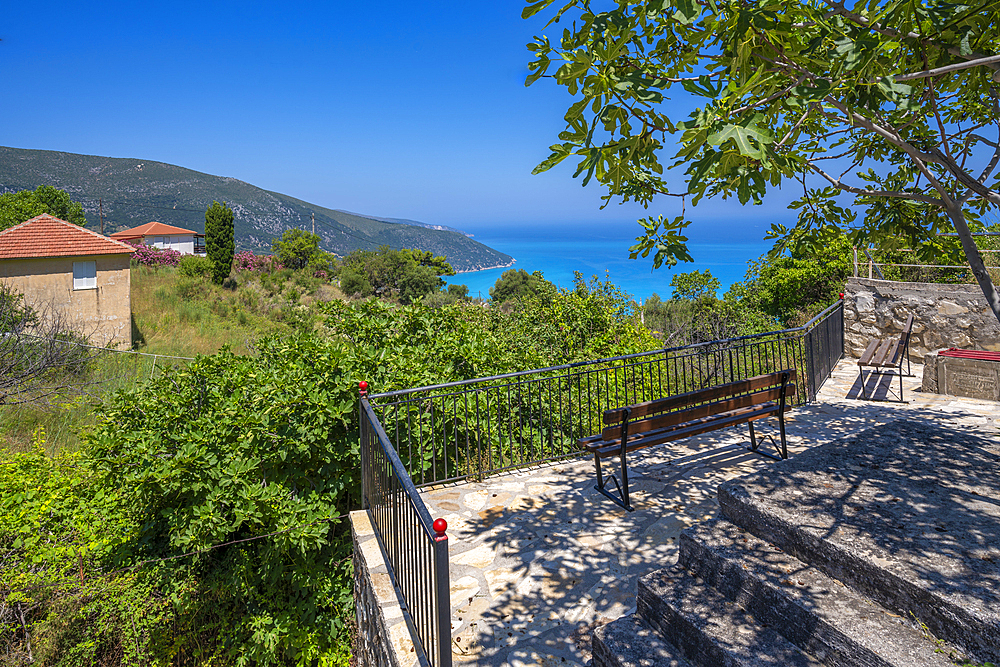 View of seat overlooking coastline, sea and hills near Agkonas, Kefalonia, Ionian Islands, Greek Islands, Greece, Europe