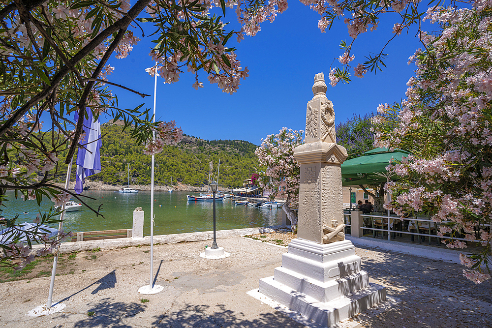 View of statue and colourful houses in Assos, Assos, Kefalonia, Ionian Islands, Greek Islands, Greece, Europe