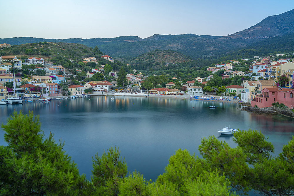 Elevated view of harbour and colourful houses in Assos at dusk, Assos, Kefalonia, Ionian Islands, Greek Islands, Greece, Europe