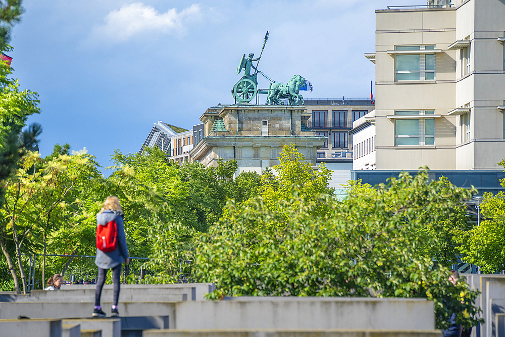 View of woman viewing Brandenburg Gate (Brandenburger Tor), Mitte, Berlin, Germany, Europe