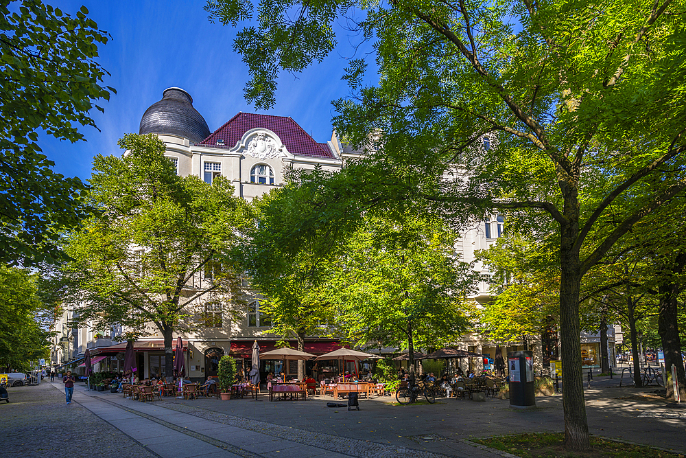 View of restaurant on the tree lined Kurfurstendam in Berlin, Germany, Europe